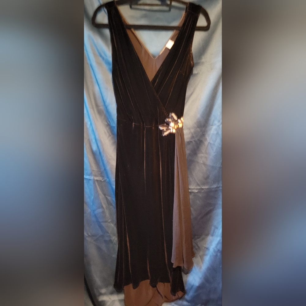Vintage black velvet cocktail dress with hip embellishment.